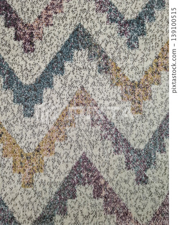 The rug features a bold geometric zigzag pattern in various colors on a grey speckled background. The view displays the intricate details and vibrant shades used in the design. The rug features a bold geometric zigzag pattern in various colors on a grey speckled background. The view displays the intricate details and vibrant shades used in the design. 139100515