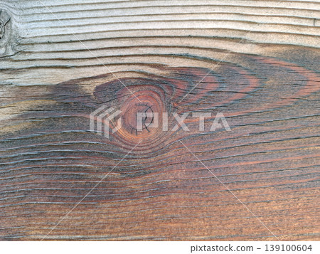 The surface displays intricate wood grain patterns with a dark reddish brown knot at the center. The natural texture highlights the beauty of the wood. 139100604
