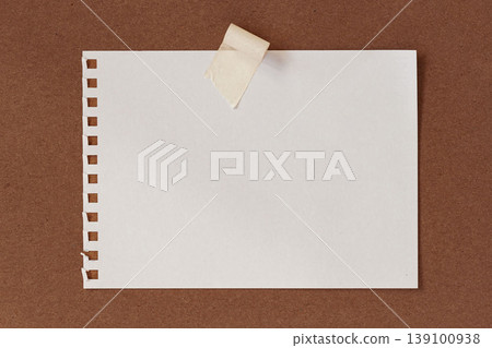 Paper sheet from notebook with perforation holes fixed by adhesive tape on cardboard surface, copy space for text, message, design layout and template use, paper mockup. Natural background Paper sheet from notebook with perforation holes fixed by adhesive tape on cardboard surface, copy space for text, message, design layout and template use, paper mockup. Natural background 139100938