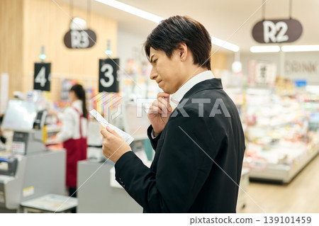 A man is dissatisfied after seeing the price on the receipt. A man is dissatisfied after seeing the price on the receipt. 139101459