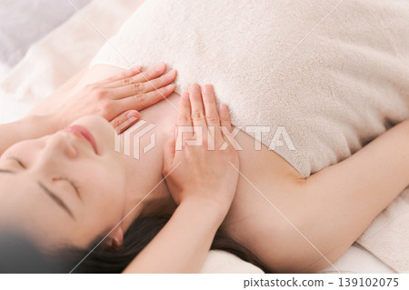 A woman who receives a treatment at an esthetic salon A woman who receives a treatment at an esthetic salon 139102075