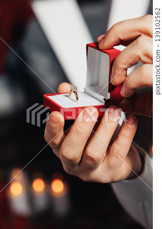Intimate Jewelry Display. Soft Lighting Highlights Exquisite Velvet Jewelry Presentation Scene. Close Presentation Showing Hands Holding Sparkling Diamond In Luxurious Velvet Box Intimate Jewelry Display. Soft Lighting Highlights Exquisite Velvet Jewelry Presentation Scene. Close Presentation Showing Hands Holding Sparkling Diamond In Luxurious Velvet Box 139102562