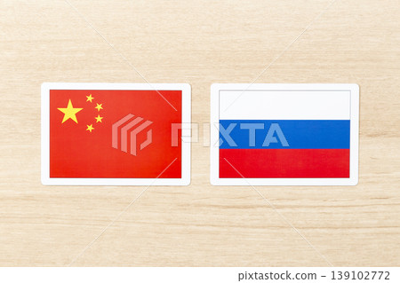 The flags of China and Russia are placed on the table. The flags of China and Russia are placed on the table. 139102772