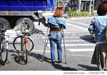 Crutch woman Crutch woman 139102779