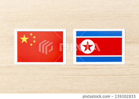 The flags of China and North Korea are placed on the table. 139102833