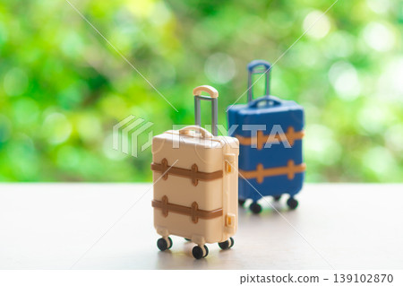 Suitcase with a natural green background Suitcase with a natural green background 139102870
