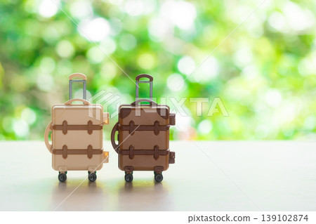 Suitcase with a natural green background Suitcase with a natural green background 139102874