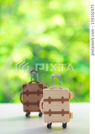 Suitcase with a natural green background Suitcase with a natural green background 139102875