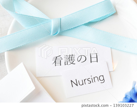 May 12th is Nurses' Day, commemorating Florence Nightingale's birthday. Blue ribbons and flowers are displayed. May 12th is Nurses' Day, commemorating Florence Nightingale's birthday. Blue ribbons and flowers are displayed. 139103227