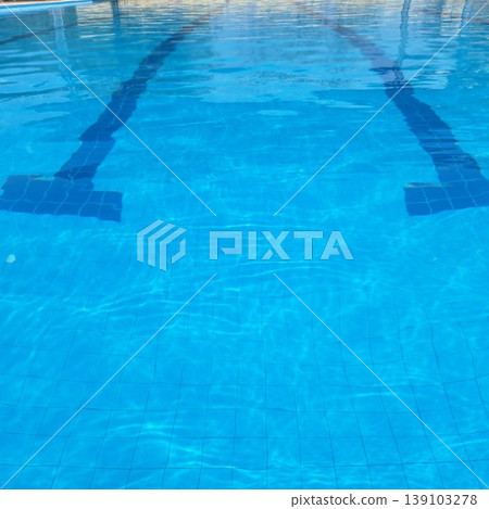 Clear Blue Swimming Pool Water Surface with Sunlight Reflections and Tile Pattern Background Clear Blue Swimming Pool Water Surface with Sunlight Reflections and Tile Pattern Background 139103278