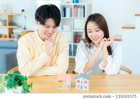 A couple thinking about buying a house A couple thinking about buying a house 139103375