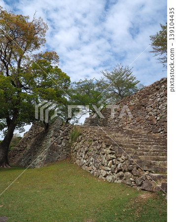 The historic stone steps leading to the main keep of Sumoto Castle on Awaji Island, and the sturdy stone walls built in the rough-hewn style. The historic stone steps leading to the main keep of Sumoto Castle on Awaji Island, and the sturdy stone walls built in the rough-hewn style. 139104435