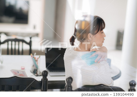 Thoughtful asian woman sitting at table using technology for remote work and quiet study inside bright modern home looking away feeling very contemplative and slightly distracted today Thoughtful asian woman sitting at table using technology for remote work and quiet study inside bright modern home looking away feeling very contemplative and slightly distracted today 139104490