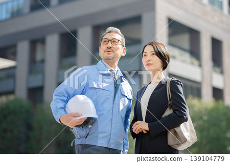 A man and a businesswoman wearing work clothes A man and a businesswoman wearing work clothes 139104779