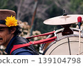 View of a bass drum with a cymbal on top, man playing bass drum on his back, Chilean chinchinero, street musician who plays the bass drum and dances in the streets, Chilean cultural tradition 139104798