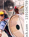 View of a bass drum with a cymbal on top, man playing bass drum on his back, Chilean chinchinero, street musician who plays the bass drum and dances in the streets, Chilean cultural tradition 139104799