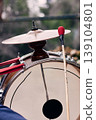 View of a bass drum with a cymbal on top, man playing bass drum on his back, Chilean chinchinero, street musician who plays the bass drum and dances in the streets, Chilean cultural tradition 139104801