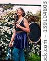 Beautiful dark-haired Latina woman posing with a drum and cymbals on her back, full of joy, a chinchinera, a street musician who dances and plays her drum in the streets. Chilean heritage 139104803