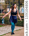 Beautiful Chilean Latina woman smiling with attitude, with her drum and cymbals on her back, detail of her musical instrument, female percussionist, street musician, dancing and playing her drum  139104806