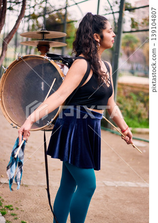 Detail of a musical instrument, bass drum and cymbals belonging to a chinchinera, a female street musician who dances and plays her drum in the streets. Chilean heritage, Chilean culture, national Detail of a musical instrument, bass drum and cymbals belonging to a chinchinera, a female street musician who dances and plays her drum in the streets. Chilean heritage, Chilean culture, national 139104807