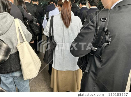 Commuters lined up on a train platform during rush hour 139105337