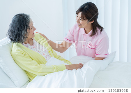 Senior woman living in a nursing home and caregiver Senior woman living in a nursing home and caregiver 139105938