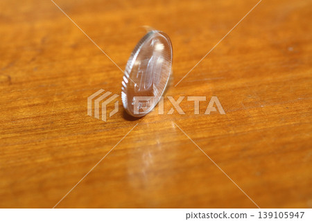 Close-up of a 500 yen coin standing upright Close-up of a 500 yen coin standing upright 139105947