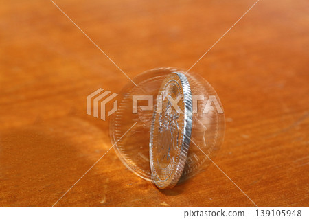 Close-up of a 500 yen coin standing upright Close-up of a 500 yen coin standing upright 139105948