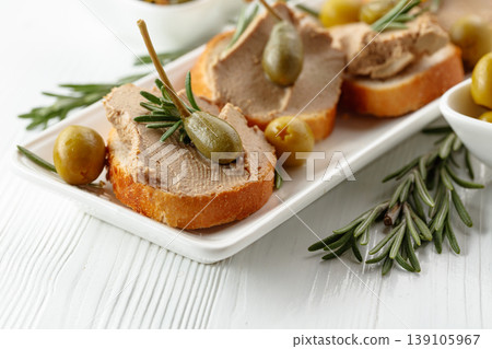 Sandwiches with pate on a white wooden table. Sandwiches with pate on a white wooden table. 139105967