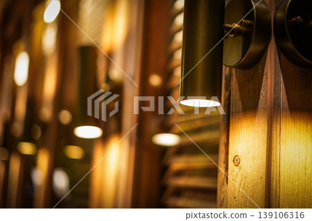 Spotlights on a wooden wall 139106316