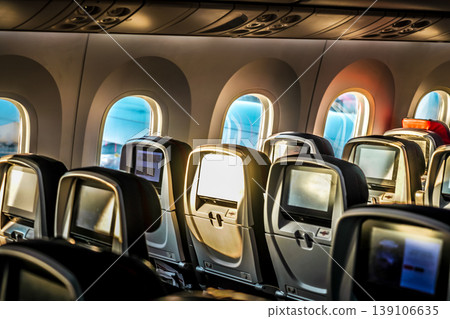 Sunlight streaming into the airplane cabin seats 139106635