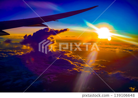 Evening view of iridescent clouds and an airplane wing Evening view of iridescent clouds and an airplane wing 139106648