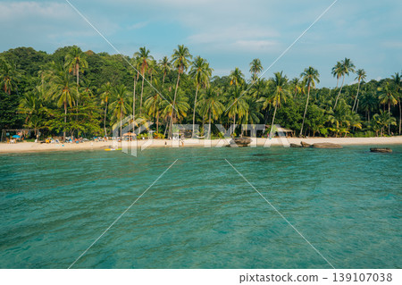 Tropical beach with white sand and coconut palm trees in Thailand. Tropical beach with white sand and coconut palm trees in Thailand. 139107038