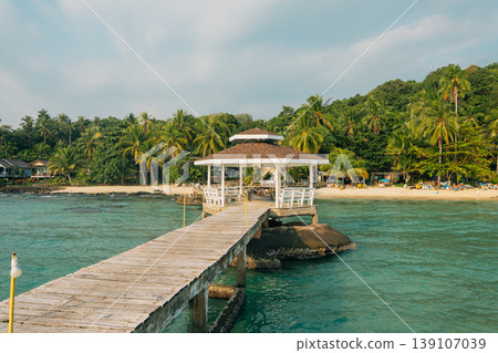 Wooden pier with pavilion on a tropical beach at sunset Wooden pier with pavilion on a tropical beach at sunset 139107039