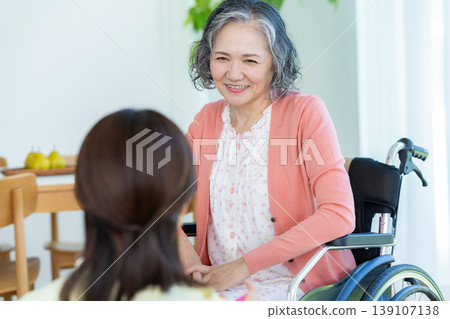 Senior woman and carer in wheelchair 139107138