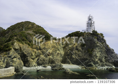 The Sada Cape Lighthouse, under construction, stands on the top of the cape, and the rock face contains a cave. The Sada Cape Lighthouse, under construction, stands on the top of the cape, and the rock face contains a cave. 139107306