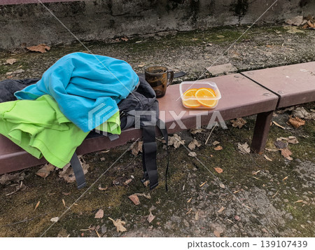 Fresh Orange Slices in Container and Coffee Mug on Bench 139107439