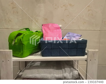 Toiletry Bag and Storage Basket on Shelf Toiletry Bag and Storage Basket on Shelf 139107440