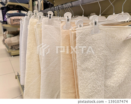 Plush Bath Towels in Neutral Colors Hanging on Rack in Home Goods Store Plush Bath Towels in Neutral Colors Hanging on Rack in Home Goods Store 139107474