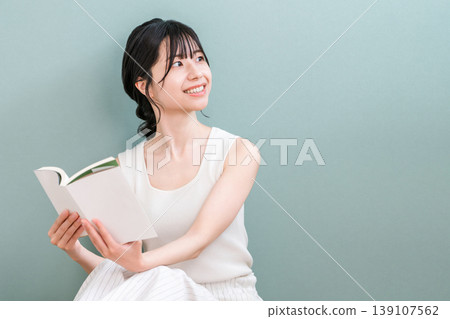 Young Asian woman reading at home (culture, reading habits, spare time, literature) Young Asian woman reading at home (culture, reading habits, spare time, literature) 139107562