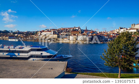 The historic cityscape of Porto along the Douro River and the blue sky. The historic cityscape of Porto along the Douro River and the blue sky. 139107571