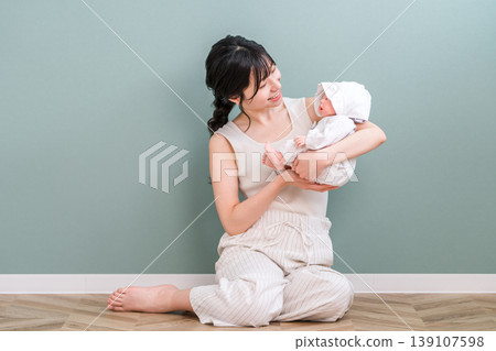 Mother holding a baby (soothing, putting to sleep, childcare) Mother holding a baby (soothing, putting to sleep, childcare) 139107598