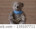 A teddy bear holding a trumpet is positioned in the center. 139107711
