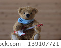 A teddy bear holding a guitar; yellow bear, red guitar 139107721