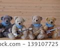 Four teddy bears holding musical instruments, lined up, slightly close-up. 139107725