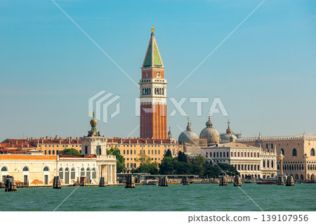 St. Mark's Campanile rising above the historic buildings, the domes of St. Mark's Basilica and the Doge's Palace in Venice, Italy. 139107956
