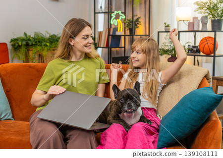 Mother daughter dog finish on laptop close project relief press submit celebrate success together Mother daughter dog finish on laptop close project relief press submit celebrate success together 139108111