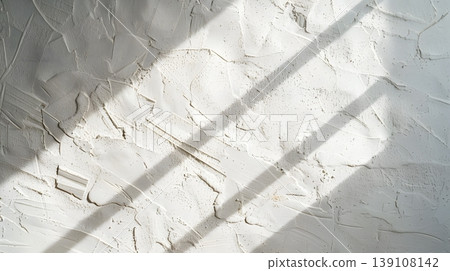White plaster walls bathed in morning light against a minimalist, wabi-sabi background. 139108142