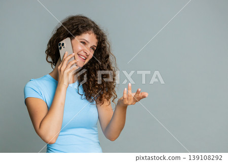Woman talking smartphone phone call emotionally gesturing hands expressive animated conversation 139108292