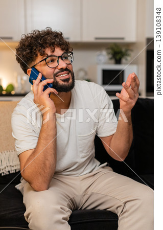 Arabian man speaks on smartphone enjoys phone call smiles listens active chat in evening with friend Arabian man speaks on smartphone enjoys phone call smiles listens active chat in evening with friend 139108348